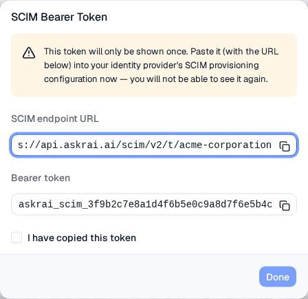 The SCIM Bearer Token dialog showing the endpoint URL, the one-time bearer token, and a confirmation checkbox